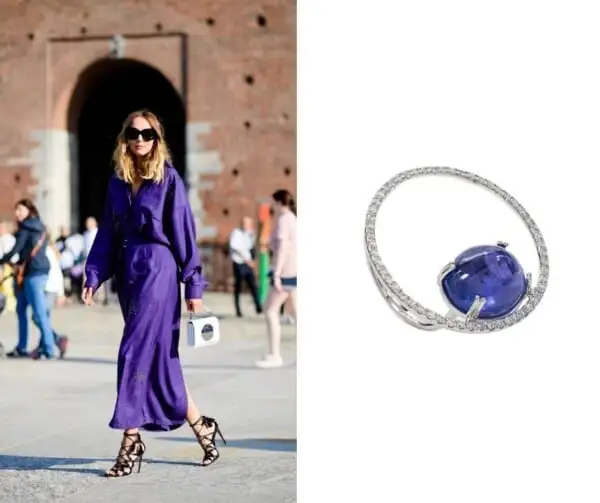 A woman passing through a square with a very peri color outfit and our jewel proposal to wear with that look